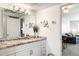 Well-lit bathroom with a granite countertop, white cabinets, and modern fixtures, offering a clean aesthetic at 5995 N 78Th St # 2079, Scottsdale, AZ 85250