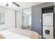 Bright bedroom featuring a mirrored closet, ceiling fan, and washer-dryer for added convenience and comfort at 5995 N 78Th St # 2079, Scottsdale, AZ 85250