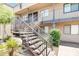 Condo exterior with tan stucco, metal stair railings, and lush desert landscaping at 5995 N 78Th St # 2079, Scottsdale, AZ 85250