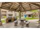 Outdoor kitchen area with stone surround, gas grills, dining table and seating at 5995 N 78Th St # 2079, Scottsdale, AZ 85250