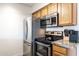 Galley kitchen with modern stainless steel appliances and bright lighting at 5995 N 78Th St # 2079, Scottsdale, AZ 85250