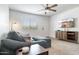Living room with modern gray sofa, ceiling fan, and TV mounted on the wall at 5995 N 78Th St # 2079, Scottsdale, AZ 85250
