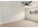 A bright, carpeted bedroom with ample natural light featuring a modern ceiling fan at 6841 E Osborn Rd # C, Scottsdale, AZ 85251