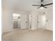 Spacious carpeted bedroom with modern ceiling fan, walk-in closet, and ensuite bathroom at 6841 E Osborn Rd # C, Scottsdale, AZ 85251