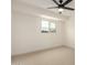 Bright bedroom with a window, ceiling fan, neutral carpet, and fresh white walls at 6841 E Osborn Rd # C, Scottsdale, AZ 85251