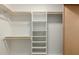 Walk-in closet with white shelving, and wooden closet rod for ample storage space at 6841 E Osborn Rd # C, Scottsdale, AZ 85251