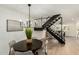Elegant dining area with a round table, modern lighting, and open staircase view at 6841 E Osborn Rd # C, Scottsdale, AZ 85251
