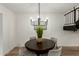 Cozy dining area with a round table, modern chandelier, and minimalist decor at 6841 E Osborn Rd # C, Scottsdale, AZ 85251