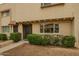 Inviting townhouse exterior featuring a cozy entrance and lush green landscaping at 6841 E Osborn Rd # C, Scottsdale, AZ 85251