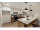 Contemporary kitchen boasting white cabinets, stainless steel appliances, a breakfast bar, and modern pendant lighting at 6841 E Osborn Rd # C, Scottsdale, AZ 85251