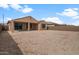 Expansive backyard featuring a covered patio, a blank canvas ready for landscaping and outdoor living at 7681 W Meadowlark Way, Florence, AZ 85132