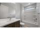 Clean bathroom with a shower-tub combo, wood-tone vanity, and bright lighting at 7681 W Meadowlark Way, Florence, AZ 85132