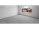 Bedroom with a neutral carpet and a large window offering natural light at 7681 W Meadowlark Way, Florence, AZ 85132