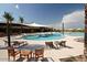 Expansive community pool area with ample seating, shaded pavilions, and a central fountain feature at 7681 W Meadowlark Way, Florence, AZ 85132