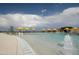 Beautiful community pool with fountain features, yellow umbrellas, and ample seating for residents to enjoy at 7681 W Meadowlark Way, Florence, AZ 85132