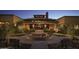Welcoming building exterior featuring brick columns, a central flowerbed, benches, and manicured landscaping at 7681 W Meadowlark Way, Florence, AZ 85132