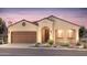Charming single-story home with a two-car garage, stucco siding, and a beautifully landscaped front yard at 7681 W Meadowlark Way, Florence, AZ 85132