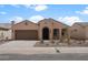 Inviting single-story home with a desert landscape, neutral stucco exterior, and a two-car garage at 7681 W Meadowlark Way, Florence, AZ 85132