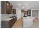 Modern kitchen with dark cabinetry, quartz countertops, tile backsplash, and a center island at 7681 W Meadowlark Way, Florence, AZ 85132