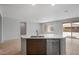 Bright kitchen featuring an island with sink, dishwasher, and stylish wood flooring at 7681 W Meadowlark Way, Florence, AZ 85132