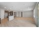 Spacious living room with tile flooring, natural lighting, and an open layout to the kitchen at 7681 W Meadowlark Way, Florence, AZ 85132