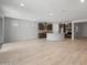 Bright living room with open concept, light tile flooring, and view of the modern kitchen at 7681 W Meadowlark Way, Florence, AZ 85132
