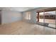 Minimalist living room with tile floors, a window with blinds, and sliding doors to the backyard at 7681 W Meadowlark Way, Florence, AZ 85132