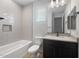 Modern bathroom featuring white subway tile, a black vanity, and contemporary fixtures at 7723 W Cactus Wren Way, Florence, AZ 85132