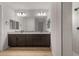 Modern bathroom featuring a double vanity, granite countertop, and walk-in shower at 7723 W Cactus Wren Way, Florence, AZ 85132