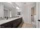 Bright bathroom featuring double sinks with modern fixtures and a tiled walk-in shower at 7723 W Cactus Wren Way, Florence, AZ 85132