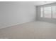 Bedroom featuring neutral carpet, white walls and window with blinds at 7723 W Cactus Wren Way, Florence, AZ 85132