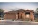 Charming single-story home featuring a stone facade, tile roof, two-car garage, and professionally landscaped yard at 7723 W Cactus Wren Way, Florence, AZ 85132