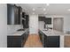 Modern kitchen featuring dark cabinets, stainless steel appliances, and granite countertops at 7723 W Cactus Wren Way, Florence, AZ 85132