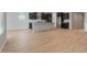Spacious kitchen and living area with wood-look floors, dark cabinetry, and stainless steel appliances at 7723 W Cactus Wren Way, Florence, AZ 85132
