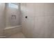 Bright shower featuring built-in bench, niche, and grey tiling at 7723 W Cactus Wren Way, Florence, AZ 85132
