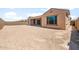 Exterior view of a backyard showing the house and block wall at 7836 W Mockingbird Way, Florence, AZ 85132