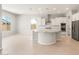 Modern kitchen with white cabinets, granite countertops, and stainless steel appliances open to living area at 7836 W Mockingbird Way, Florence, AZ 85132
