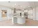 Bright open kitchen featuring white cabinetry, stainless appliances, granite countertops and a large island at 7836 W Mockingbird Way, Florence, AZ 85132