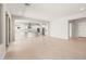 Spacious living area adjacent to kitchen with tile floors and sliding doors for natural light at 7836 W Mockingbird Way, Florence, AZ 85132