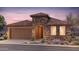 Beautiful single story home with a stone facade, tile roof, landscaped yard, and a two car garage at 7851 W Meadowlark Way, Florence, AZ 85132