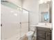 Bathroom featuring a glass-enclosed shower and vanity with dark wood cabinets and brushed gold hardware at 7870 W Mockingbird Way, Florence, AZ 85132
