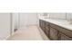 Bathroom featuring a double sink vanity with modern fixtures and wood-look tile flooring at 7870 W Mockingbird Way, Florence, AZ 85132