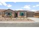 Charming single-story home featuring stone accents, desert landscaping, and a tile roof at 7870 W Mockingbird Way, Florence, AZ 85132