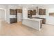 Bright kitchen features a large island, stainless steel appliances, tile backsplash and wood cabinets at 7870 W Mockingbird Way, Florence, AZ 85132