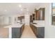 Bright kitchen features a large island, stainless steel appliances, gas cooktop and wood cabinets at 7870 W Mockingbird Way, Florence, AZ 85132