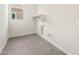 Laundry room with gray tile floors and hookups for a washer and dryer at 7870 W Mockingbird Way, Florence, AZ 85132