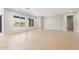 Large open-concept area featuring light wood-look tile flooring and neutral walls, bathed in natural light at 7870 W Mockingbird Way, Florence, AZ 85132