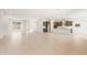 Expansive living space featuring light wood-look tile flooring, a modern kitchen, and plenty of room at 7870 W Mockingbird Way, Florence, AZ 85132