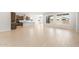 Open-concept living area featuring light wood-look tile flooring and a modern kitchen with stainless appliances at 7870 W Mockingbird Way, Florence, AZ 85132