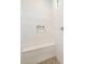 Shower with white tile surround, a built-in seat, and a recessed shower niche at 7870 W Mockingbird Way, Florence, AZ 85132